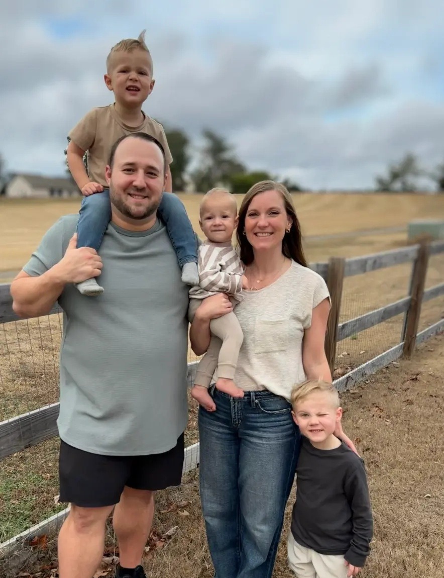 Jamie with his wife and three boys in a field